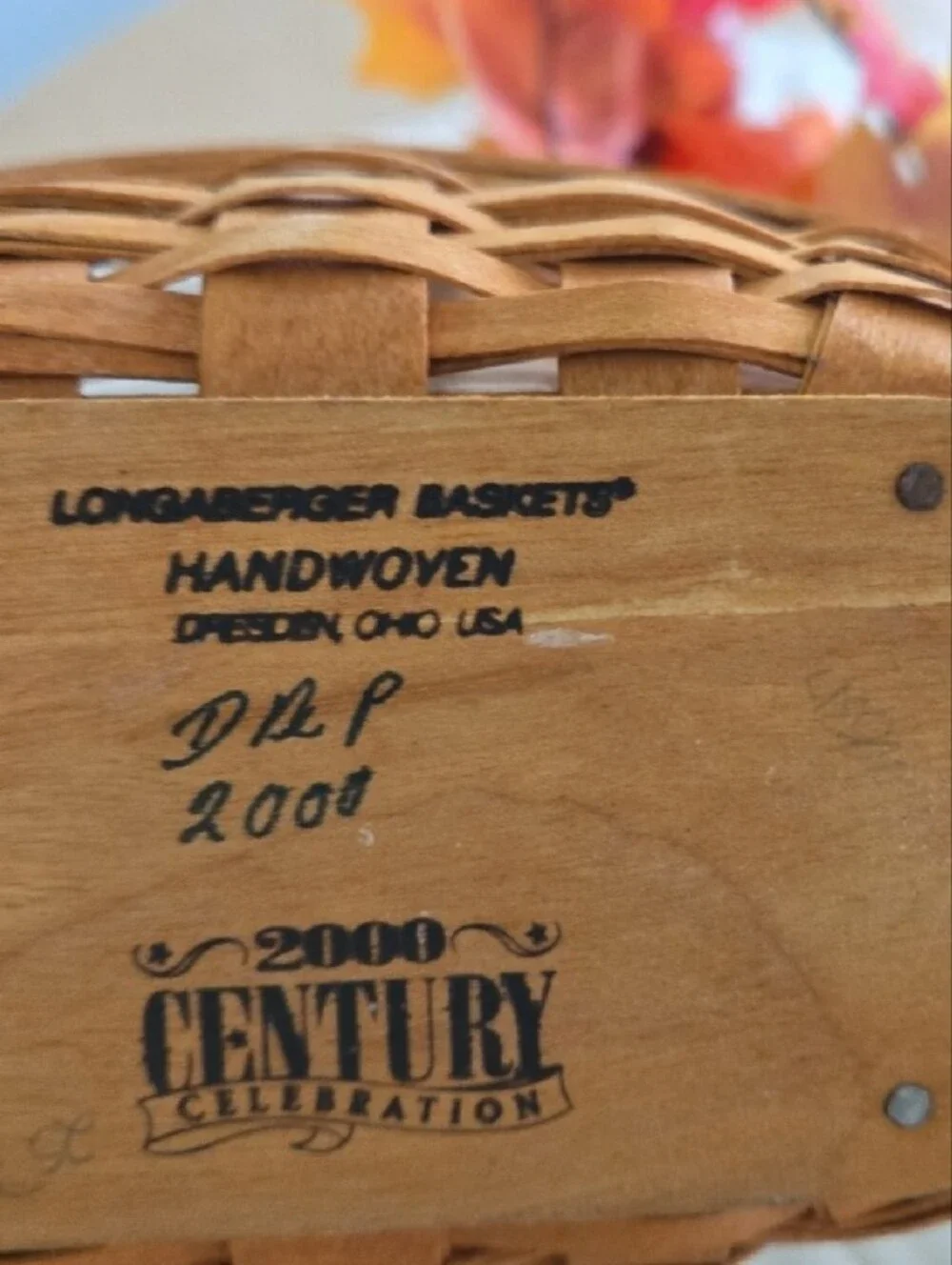 Longaberger woven basket with orange and yellow fall foliage